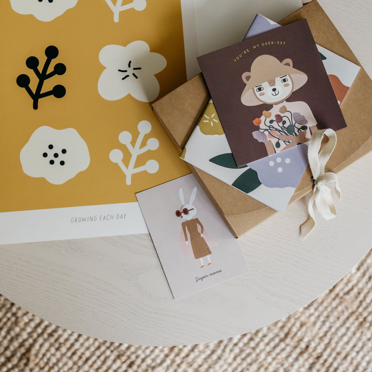 Set of greeting cards with floral and animal designs on a round surface.
