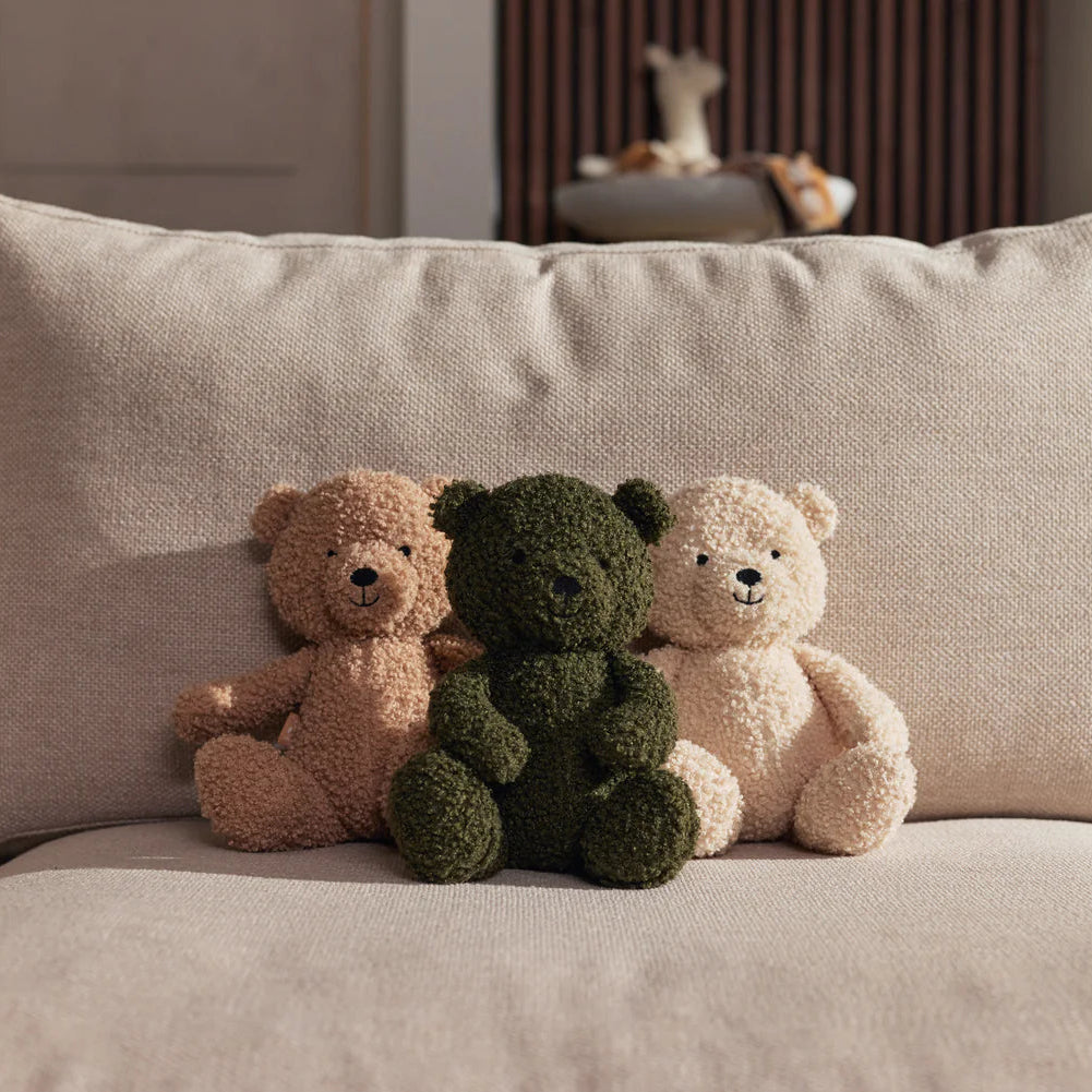 stuffed animal teddy bear collection displayed on sofa