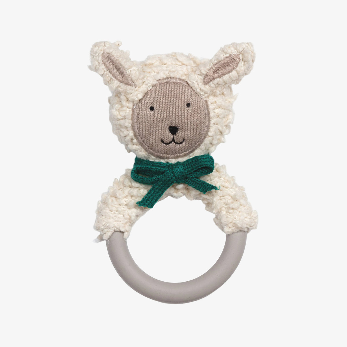 A plush sheep rattle toy with a cream-colored textured fleece body, a beige embroidered face, a dark green bow, and a gray silicone ring handle, shown on a plain white background.