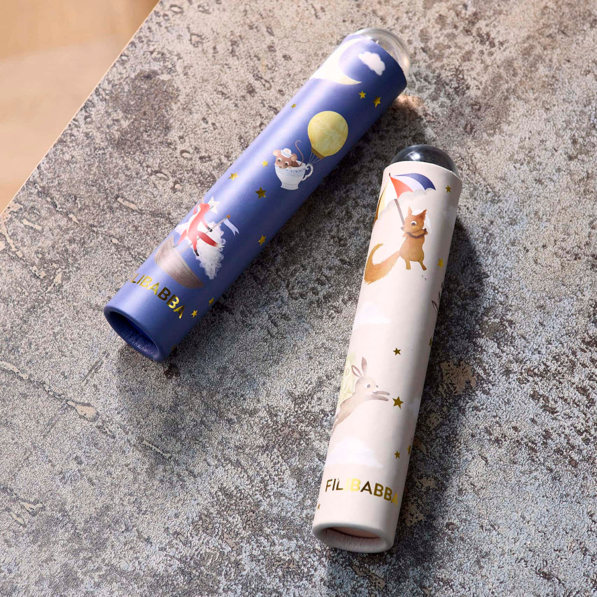 Two cylindrical products with cartoon designs on a textured surface