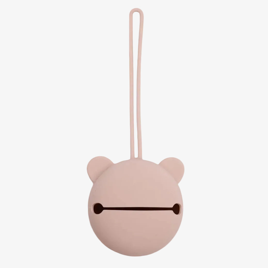 A pale pink silicone bag with a minimalist bear face design and a hanging loop, shown on a solid white background.