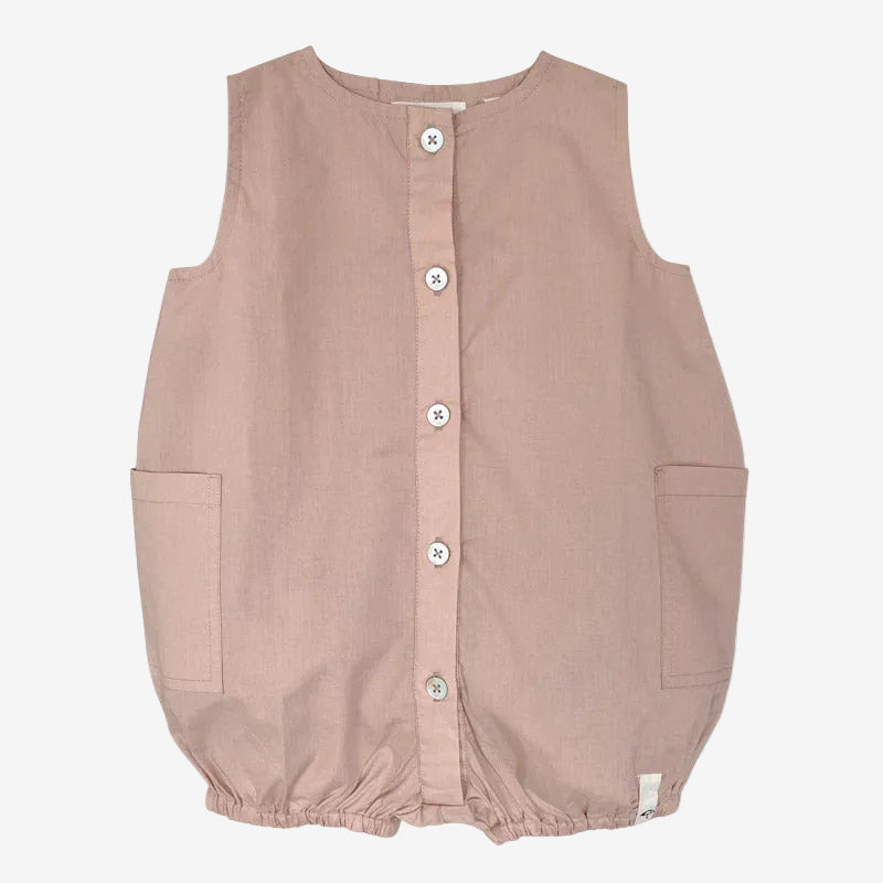 Pink sleeveless romper with button details on a white background